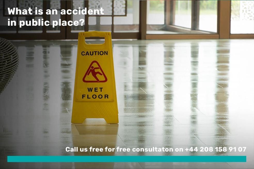A person mopping a wet floor in the lobby of a hotel, with caution signs visible in the background.